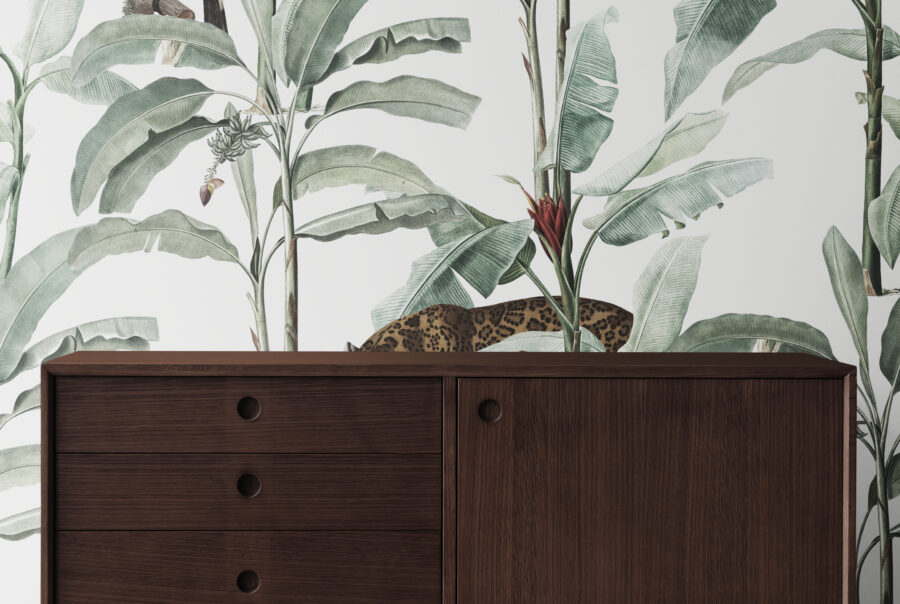 Mid century modern wood cabinet by a leafty wallpaper